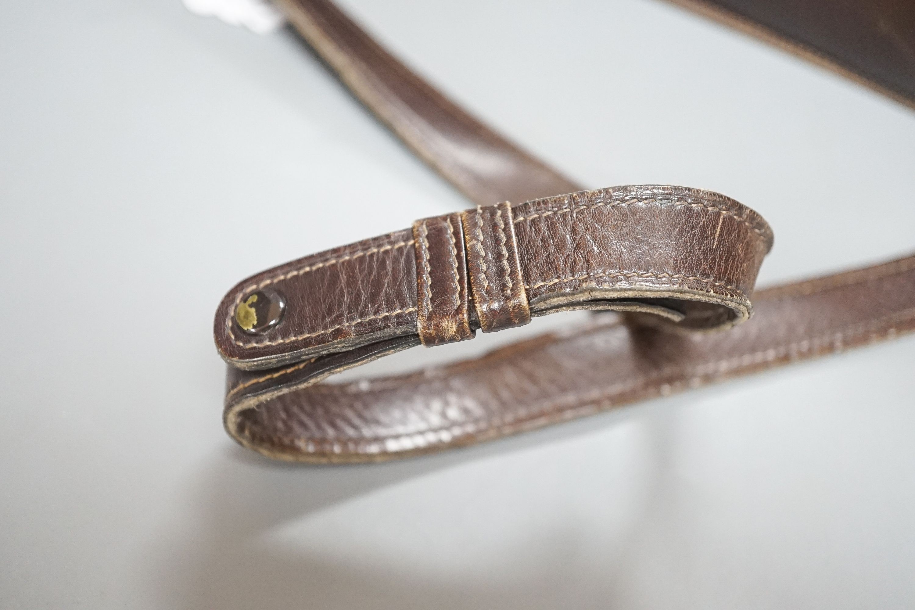 A vintage brown leather handbag stamped 